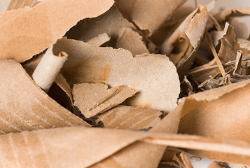 Close up of side view of a textured recycled packing cardboard with natural fiber parts