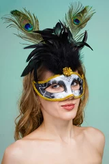 Fototapete Karneval Carnival dancer woman wearing a mask posing on green  © StepStock