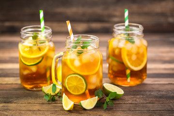 Fototapeta na wymiar Ice tea with lemon, lime and mint 