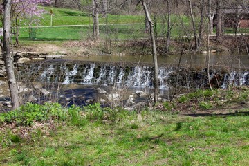 The waterfall though the bare trees.