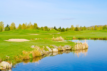 Beautiful golf place with gorgeous green, pond in winter