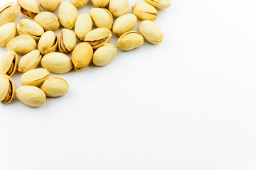 Isolated roasted pistachios nuts on a white background