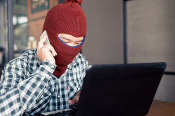 electronic crime concept. hacker is calling while using computer.