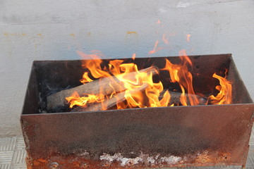 the fire on the grill to roast meat on the coals