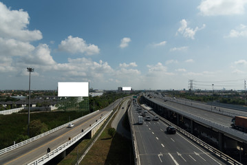 Fototapeta na wymiar bird eye view of highway beside habitat with skyline and blue sky cloud. light and shadow from nature light in day.