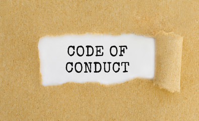 Text Code of Conduct appearing behind ripped brown paper.