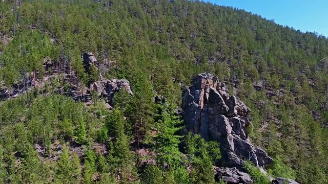 Natural rocks on a mountainside covered with vegetation
