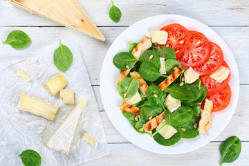 grilled chicken breast, spinach, tomato salad
