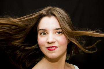 Fototapeta premium Portrait of Beautiful Young Woman Shaking Her Hair