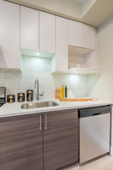 Modern, bright, clean, kitchen interior with stainless steel appliances in a luxury house