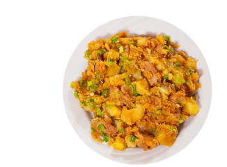 stewed meat with potatoes, onion on plate. top view. isolated on white