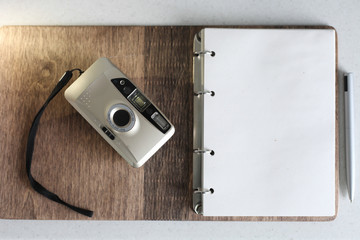 Film camera with a Notepad and a pen.