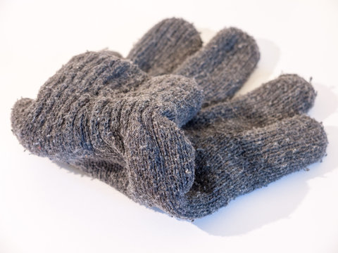 a close up stock photo of a grey glove used for hands in winter to keep warm, flded and neat, wool and cotton
