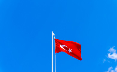 turkish flag waving in blue sky