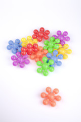 Colorful plastic toy pieces on white background