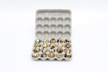 quail eggs in in a cardboard case isolated on white background 