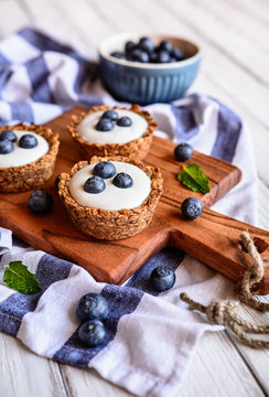 Nutritious granola cups filled with yoghurt and blueberry