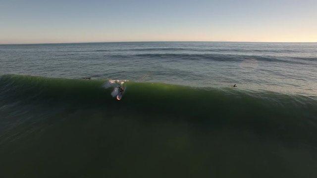 Standup paddle board surfing (SUP) a wave, aerial view New Zealand