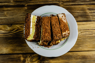 Sliced biscuit cake in plate. Top view