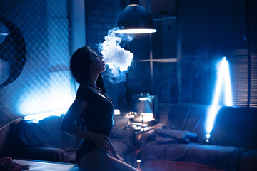 vapor concept,sexy young woman in lingerie vaping e-Cigarette