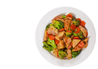 stewed meat with broccoli and carrot. top view. isolated on white