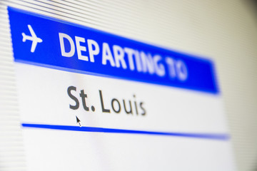 Computer screen close-up of status of flight departing to St Louis, Missouri, USA