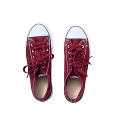 Red sneakers isolated on white background, top view close up