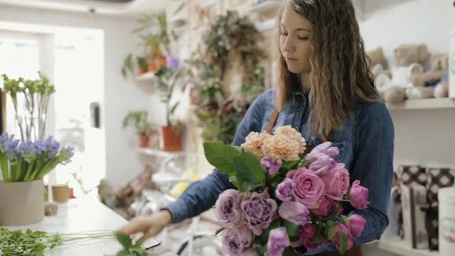 Florist woman make a bouquet of beautiful flowers