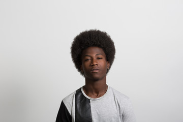 Portrait of young man standing against white background