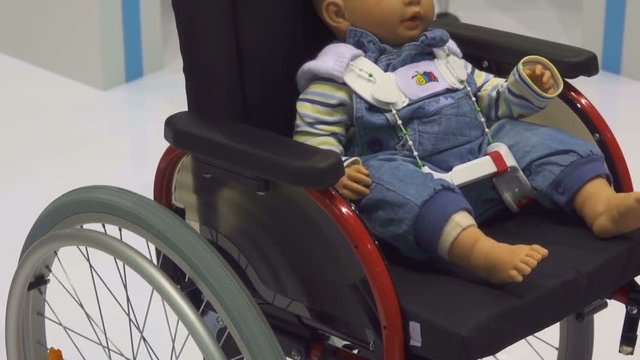 Children's dummy in a wheelchair