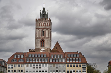 Fototapeta na wymiar Old town townhouses and Gothic church tower in Frankfurt on the Oder.