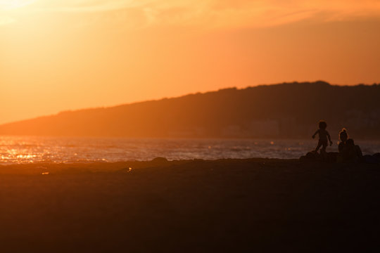 People on the beach sunset © Weston