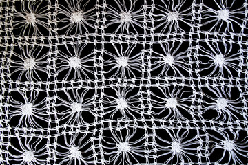 Handmade, white crochet, embroidery, on a black background, contrast