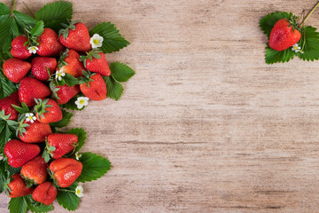 Strawberry arrangement over light wooden background with copy space