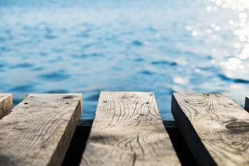 Old Wooden Pier with Blurred  Sea on the Background