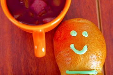 Elegant setup traditional tasty latin american guagua breads, colorful sugar decorations, orange cup with colada morada berry juice next to it, day of the dead concept