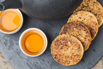 The teapot and tea on the wooden table, delicious snacks
