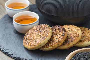 The teapot and tea on the wooden table, delicious snacks