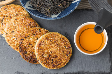 The teapot and tea on the wooden table, delicious snacks