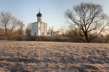 Horizontal view of an ancient church at dawn, a frosty morning, early spring