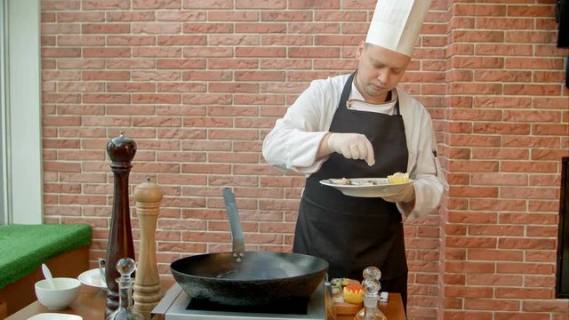 Professional chef cooking seafood in pan