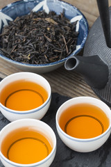 The teapot and tea on the wooden table, delicious snacks