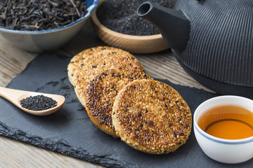 The teapot and tea on the wooden table, delicious snacks