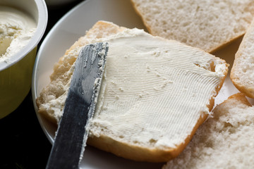 Closeup shot of sandwich with cream cheese and knife