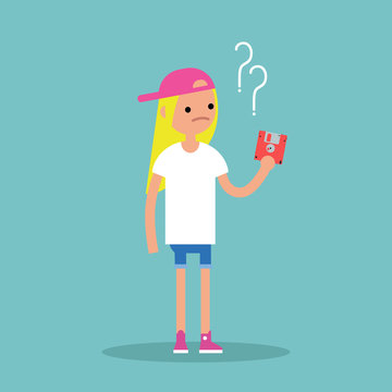 Outdated technology concept. Young blond girl has no idea what to do with the floppy disk / flat editable vector illustration
