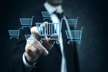 Businessman pressing shopping basket icon