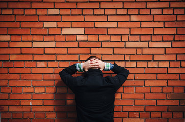 USA, Mexico, migration. Bandit, criminal, offender, hacker, hooligan arrested and standing near a...