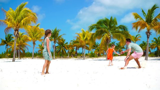 Father and little kid have a lot of fun on white sandy beach on their holidays