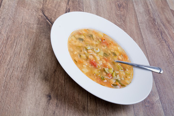 Vegetable soup on a wooden table