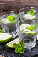 Mojito cocktail in a bur on a rustic table, selective focus